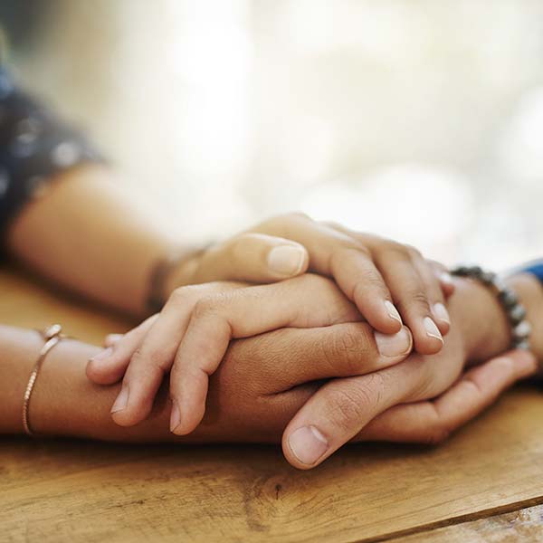 Woman holding a hand of another person